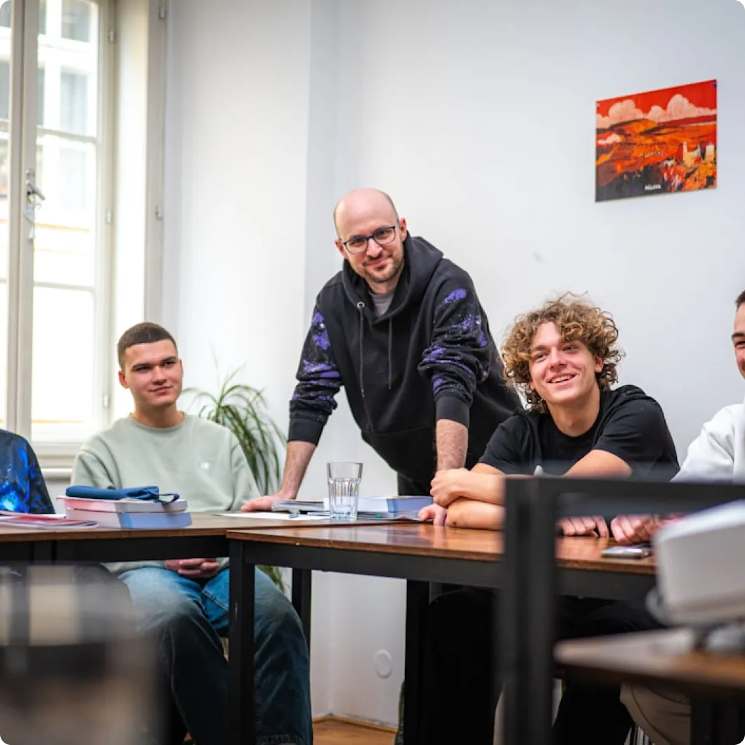 Group of male leaders sitting at tables in a meeting